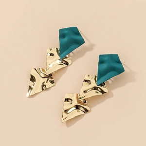 Detail of irregular geometric earrings with matte dark green and shiny gold metallic finish