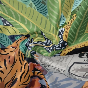 Detail of tropical jungle tapestry with tiger print and lush green botanical patterns