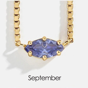 Detail of September gold necklace with marquise blue stone and box chain