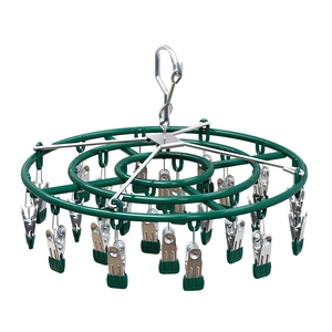 Green stainless steel round drying rack with 20 clips and windproof hook on white background
