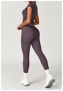 Rear view of purple short sleeve compression yoga top and high waist leggings set