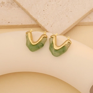 Gold-plated V-shaped geometric earrings with green marble resin inlay on stone pedestal