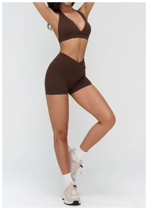Close-up of brown yoga set featuring crossover waistband shorts and V-neck sports bra