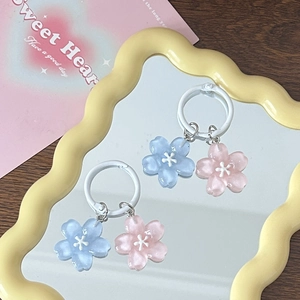Romantic jelly cherry blossom pendants in pink and blue on a yellow wavy mirror surface