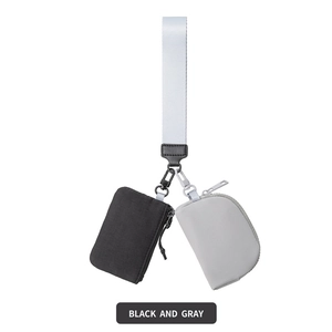 Detail of black and gray nylon wristlet pouches with metal clips and a white strap