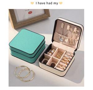 Compact PU leather jewelry box detailing interior slots for rings and necklaces