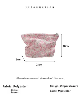 Detail showing pink floral makeup bag dimensions 23x18x5cm with durable polyester fabric