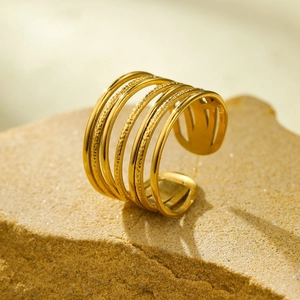 Detail of 18k gold irregular multi-layer open ring with hammered texture on natural stone