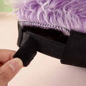 Detail of adjustable black Velcro strap on baseball cap with purple synthetic hair