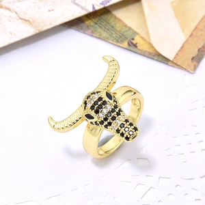 Hip hop style bull head ring with pavé zircons in gold finish on vintage background
