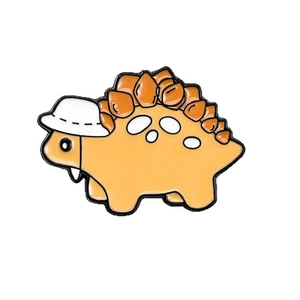 Cute orange and brown cartoon dinosaur enamel pin badge with a white hat accessory