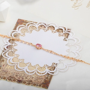 Detailed close-up of rose gold double-layer bracelet with pink corundum gemstone