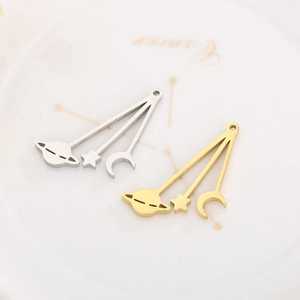 Detailed view of silver and gold celestial pendants on a ceramic astrology plate