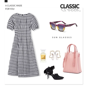Detailansicht der stylischen Sonnenbrille kombiniert mit einem schwarz-weiß karierten Kleid