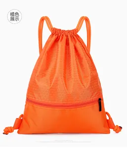 Detail view of orange drawstring bag with honeycomb texture and front zipper pocket