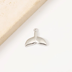 Close-up of a polished silver fish tail pendant made of stainless steel for DIY jewelry
