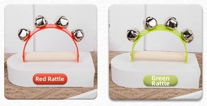 Close-up of baby wooden hand bells in red and green colors with five silver metal bells