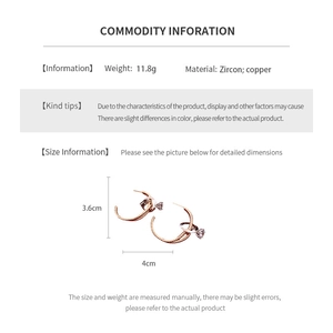 Detailed size chart of C-shaped geometric earrings featuring cubic zirconia and copper