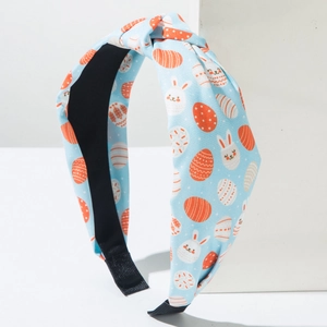 Detail of light blue Easter headband with cute bunny and egg prints and knotted design