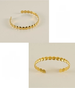 Detailed view of adjustable stainless steel cuff bracelet with golden geometric discs