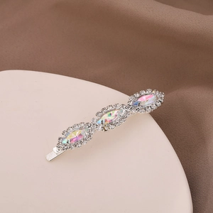 Close-up of silver hair clip with colorful crystals and detailed spring back mechanism