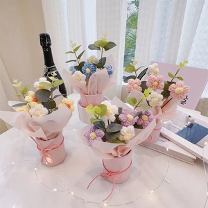 Hand-knitted flower bouquets in pink pots with green leaves and ribbon for Mother's Day