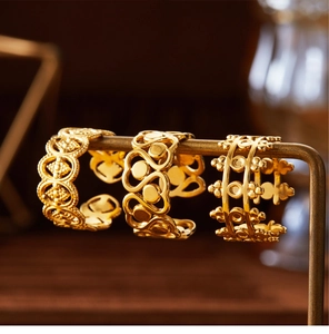 Three-layer hollow floral 18K gold plated vintage crown open rings hanging on a metal stand