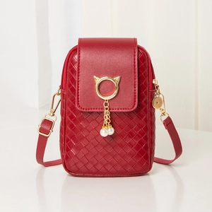 Detail of red crossbody phone bag with woven texture and gold cat-ear pearl buckle