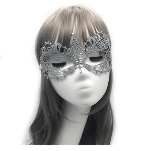 Close-up of silver lace masquerade mask with intricate vine patterns and rhinestones