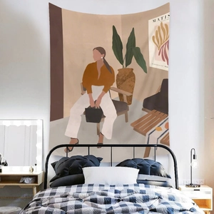 Detail of bohemian wall tapestry featuring abstract woman and plant in modern bedroom