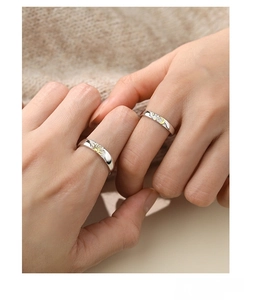 Detail of S925 silver sun and moon couple rings worn together with polished finish