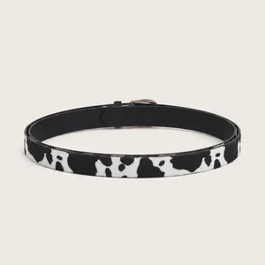 Women's faux calf hair belt with classic black and white cow print and gold buckle