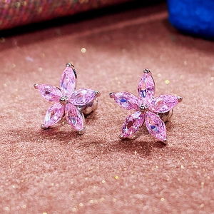 Macro shot of pink floral stud earrings with marquise-cut crystals and silver base