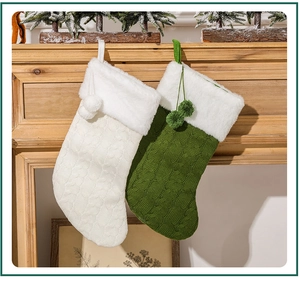 Close-up of green and white cable knit Christmas stockings hanging on a wooden mantel