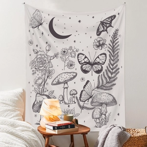 Detail of bohemian tapestry featuring butterfly, mushroom, and crescent moon patterns