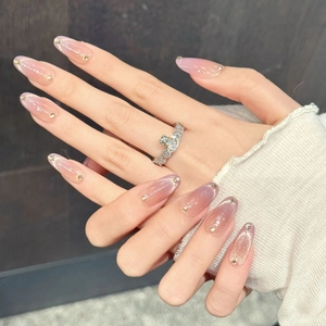 Pink gradient almond press-on nails with fine glitter and delicate rhinestone accents