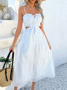 Detail view of white bohemian dress featuring tiered layers and hollow-out waist design