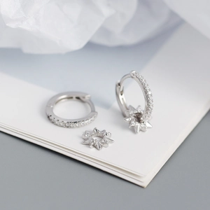 Detailed macro of S925 silver hoop earrings with a detachable starburst zircon pendant
