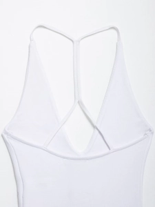 Close-up of white ribbed bodysuit showing thin Y-back crisscross strap details