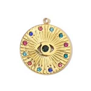 Detail of gold evil eye pendant with green stone and colorful crystal inlays