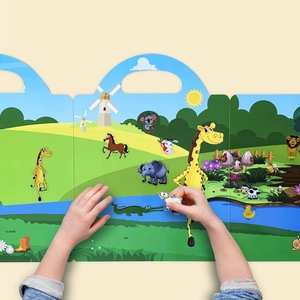 Close-up of child placing animal stickers on a reusable farm and wildlife themed book