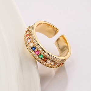 Luxurious 18K gold plated ring with vibrant rainbow cubic zirconia on a white plate