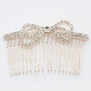 Sparkling rhinestone bow hair comb in gold finish for elegant wedding hairstyles