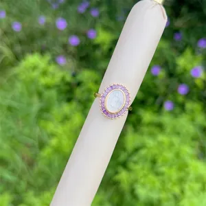 Detailed macro view of an oval vintage gold ring with purple zircons and Mary relief