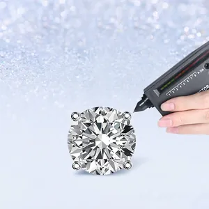 Classic 4-prong moissanite stud earring in S925 silver being tested with a diamond tester