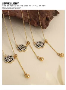 Macro view of gold rose necklace with micro-pawn crystals and polished weight charm