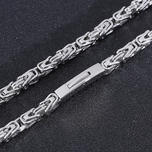Detail of 6mm silver stainless steel Byzantine chain with mechanical clasp and polished finish