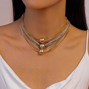 Layered gold and silver metal chain necklace with three spherical pendant accents