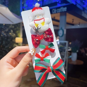 Detail view of 5-piece Christmas hair clip set with plush snowman and reindeer bow