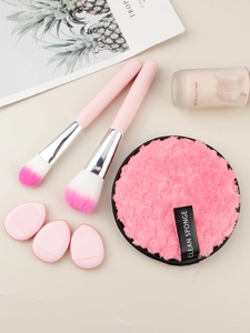 Pink makeup brush set featuring soft foundation brushes and plush cleaning sponges